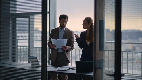 Business People Reviewing Documents Having Conversation Architecture View Office