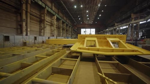 Inside a Detailed Shipbuilding Facility Featuring Various Assembled Hull Sections and More Stock