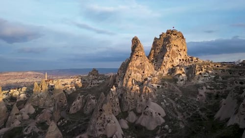 Aerial drone view of the Uchisar Castle in Cappadocia, Turkey during sunset