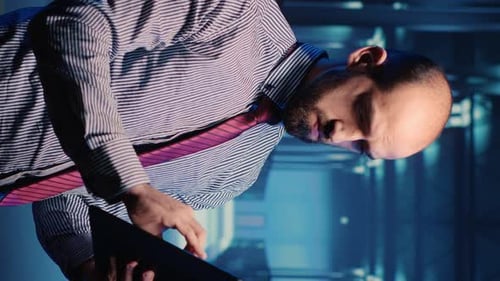 Vertical Video Data Center IT Engineer Standing in Server Room