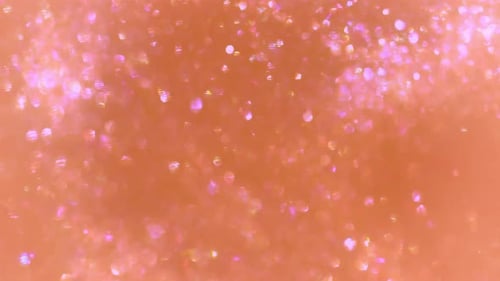 Glitter sparkles shine on peach background