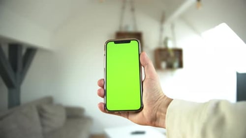 Hand Swiping Phone Green Screen in Living Room