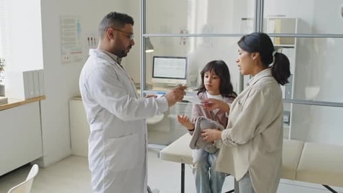 Doctor Consults with Woman and Child Patient