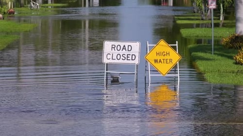 Hurricane Milton in Florida Road Under Water Warning Sign City Street Closed Because of Flooding