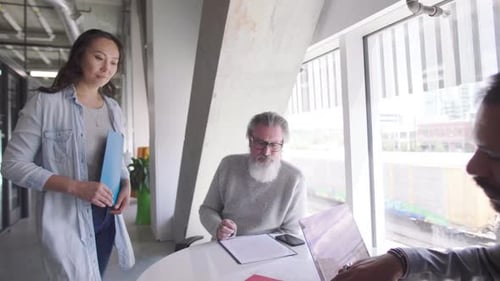 Business People with Paperwork Talking in Office Meeting Business