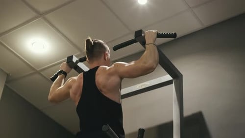 Athlet macht Klimmzüge im Fitnessstudio