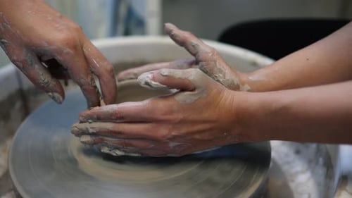 Hands Shaping Clay on a Pottery Wheel