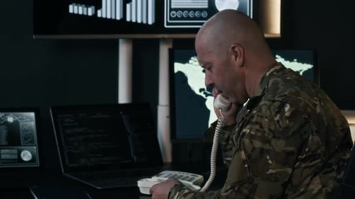 Sergeant Having Nervous Phone Talk while Monitoring in Surveillance Office