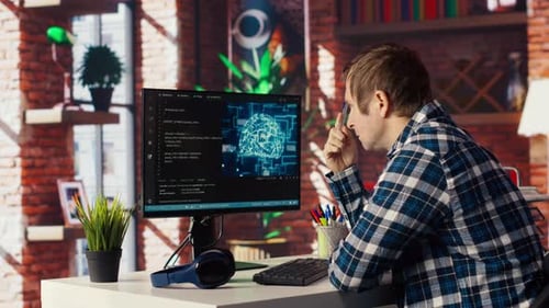 AI Software Developer at Computer Waiting for Code to Finish Compiling