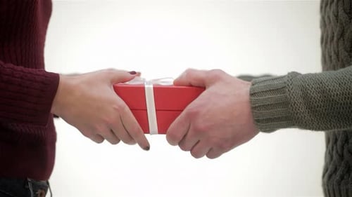 Close Up Male Hands Giving a Gift to Girl