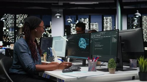 Software Developer in Office Using Laptop to Fix Artificial Intelligence Bugs