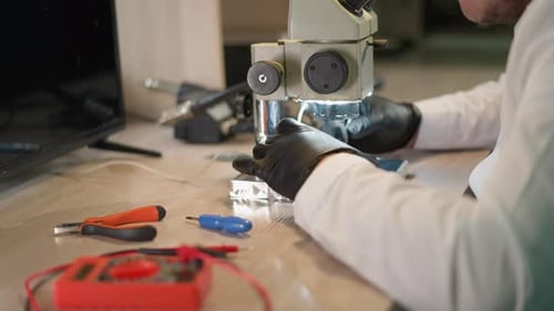 Scientist Works with Microscope in Bright Workplace