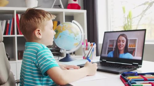 Boy Doing Homework on Laptop with Online Teacher