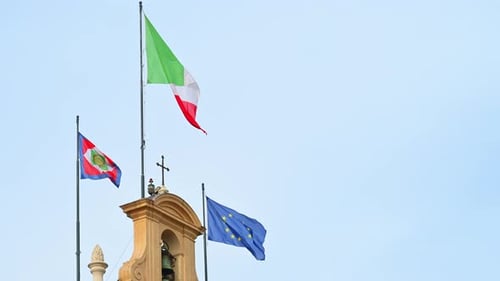 Italian, EU Flags Wave from Building on Breezy Day