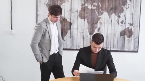 the manager checks the documents, the businessman is not satisfied with the work done