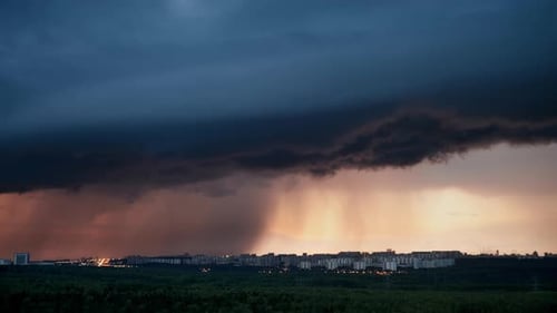 Dramatic Sunset Over City Skyline with Approaching Storm