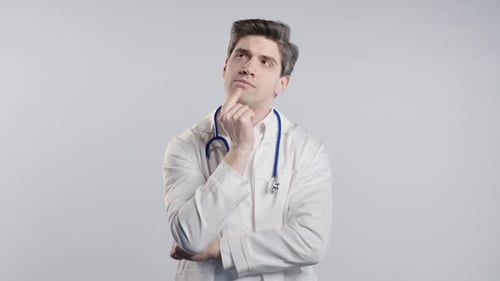 Thoughtful Doctor Wearing White Coat and Stethoscope