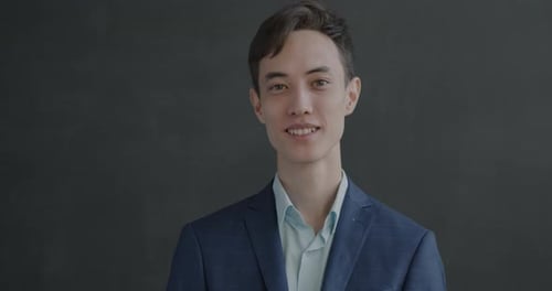 Young Man Smiling and Gesturing Okay