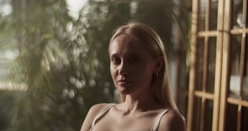 Portrait of Young Blond Haired Artist Sitting in Home Studio