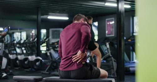 Gym, athlete and man with back pain, hurt or training injury after exercise routine