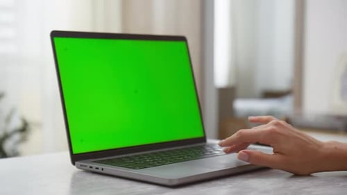 Closeup of Hand Using Laptop with Green Screen
