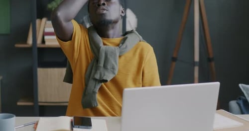 Adult Working at Laptop in Home Office