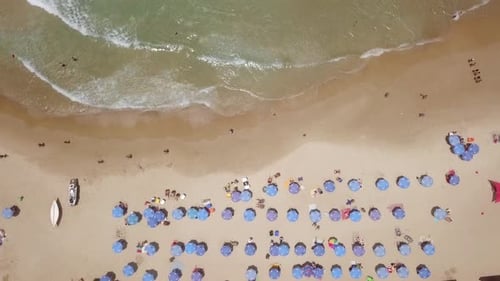 Summertime in a public Beach with colorful umbrellas