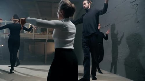 Dance Rehearsal of Group in Dimly Lit Studio