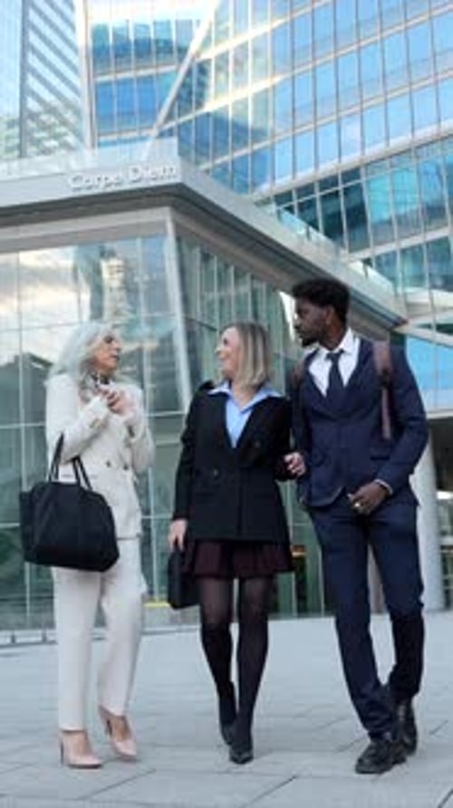 Diverse Business Team Walking and Talking in a Modern City Financial District
