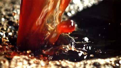 A Stream of Black Coffee with Splashes Filmed on a Highspeed Camera at 1000 Fps