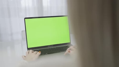 Woman Typing on Laptop with Green Screen a Rectangle Flat Panel Display Gadget