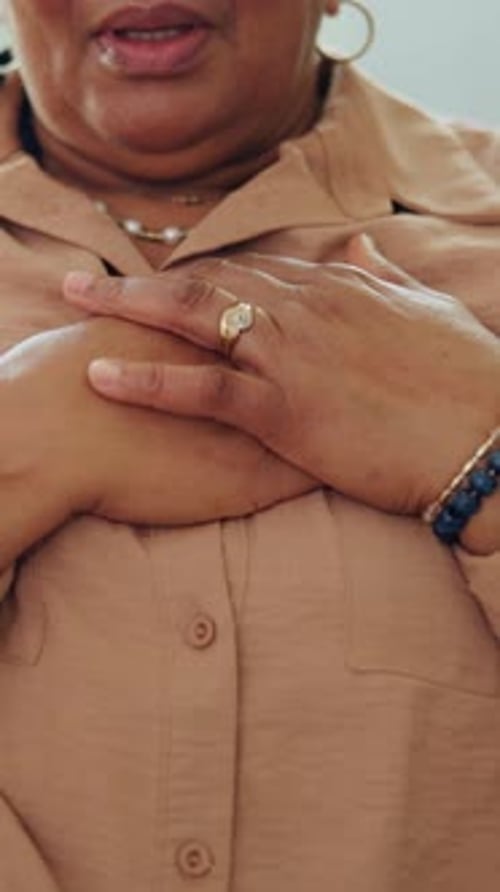 Woman Clasping Hands in Peaceful Indoor Setting