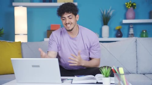 Man Typing on Laptop at Home on Sofa