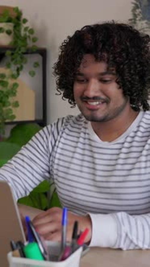 Young Indian Man Working on Laptop at Home Office