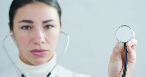 close up portrait of woman doctor with stethoscope ready for visit in hospital or clinic.