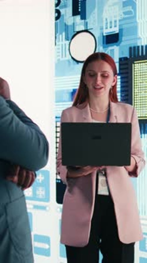 Corporate Meeting: Woman with Laptop Explains to Colleague