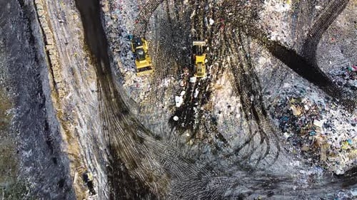 Aerial flyover landfill full of trash, pollution environmental problem, garbage, trucks dump waste p