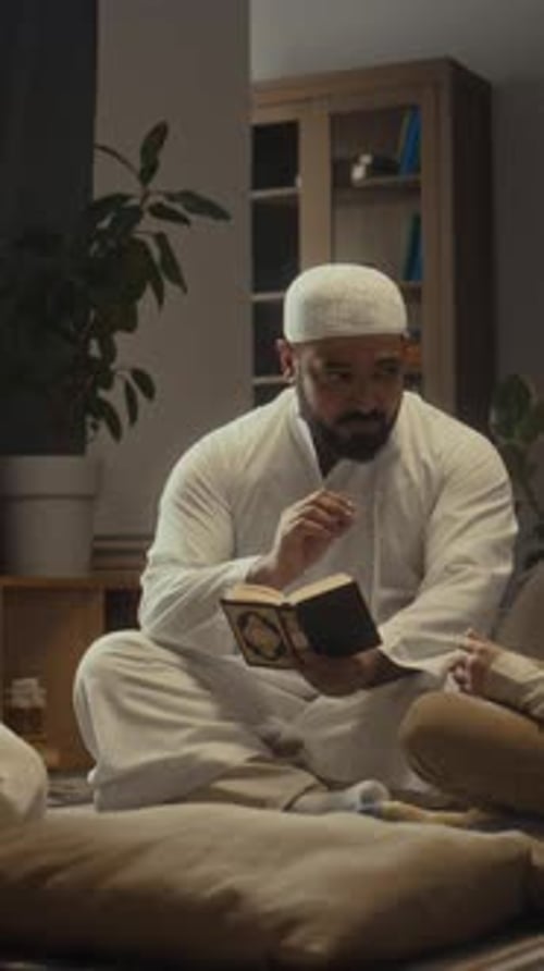 Vertical of Muslim Father Giving Religious Education to Son