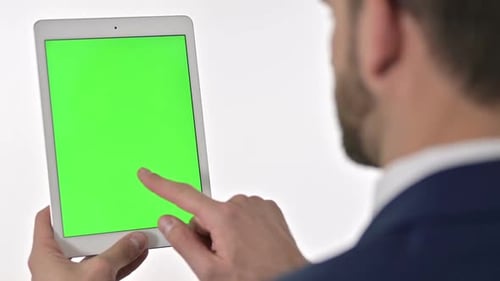 Man Using Tablet with Green Screen