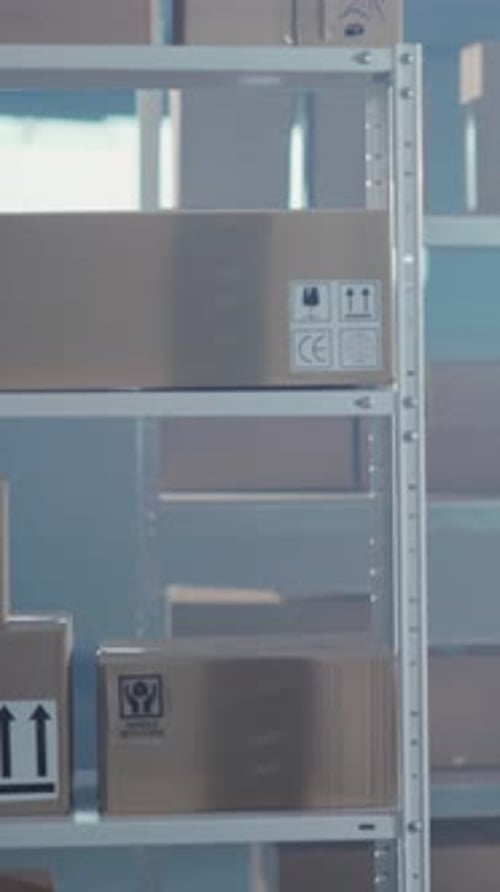 Man in Vest Handshake in Front of Packages