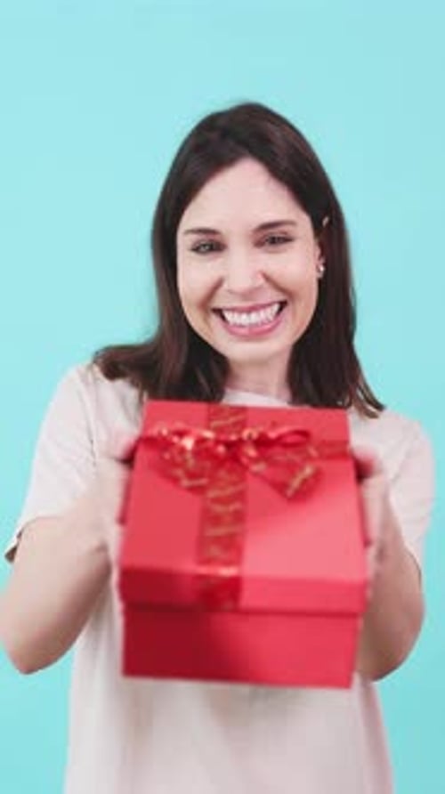 Young Woman Presents Red Gift with a Smile