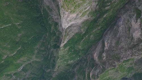 An incredibly beautiful view from above on a steep rock and a mountain abyss going down.