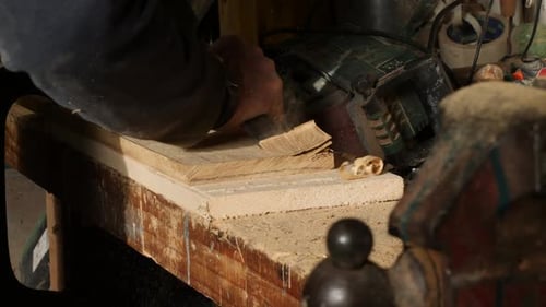 Close-up of a Carpenter Using a Chisel to Remove Large Wood Pieces