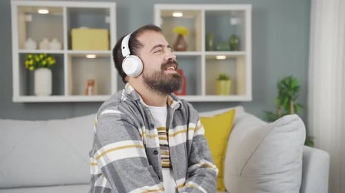 Bearded Man Listening to Music on Headphones