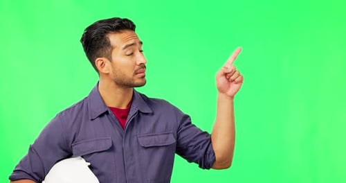 Asian man, engineer and pointing on green screen for wrong plan, no or negative against a studio
