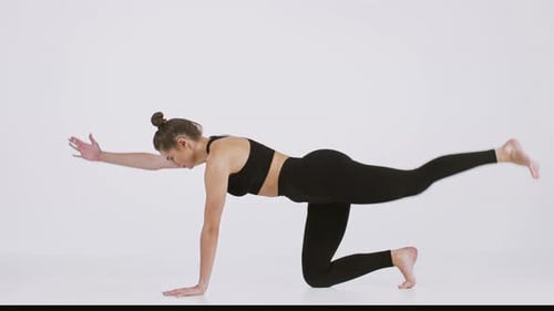Woman Practicing Yoga Stretches for Health and Fitness in Studio Setting