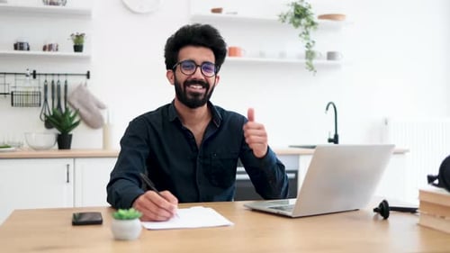 Smiling Man Working from Home with Laptop