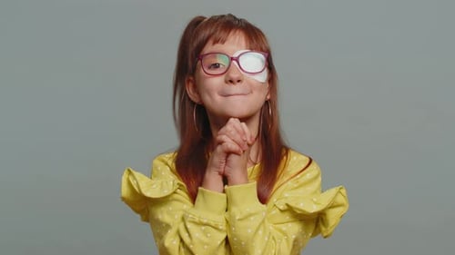 Smiling Child with Eye Patch Celebrates