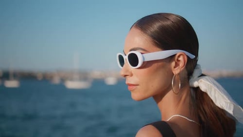 Portrait Elegant Lady Taking Off Trendy Sunglasses at Sunny Ocean Coast