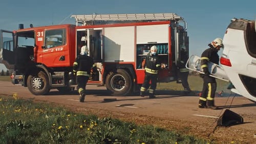 Firefighters Arrive on the Car Crash Traffic Accident Scene on their Fire Engine. Firemen Grab thei